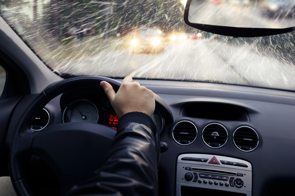 Person driving a car in the rain before an accident that needs the help of a car accident lawyer